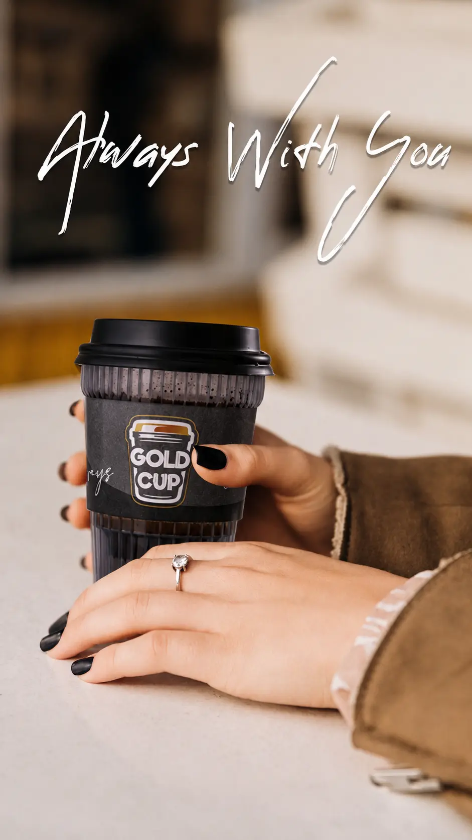 A Gold Cup Espresso held in hand